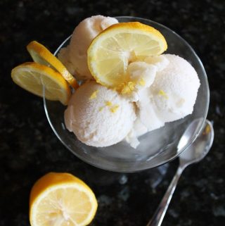 glass bowl of ice cream with fresh lemon slices