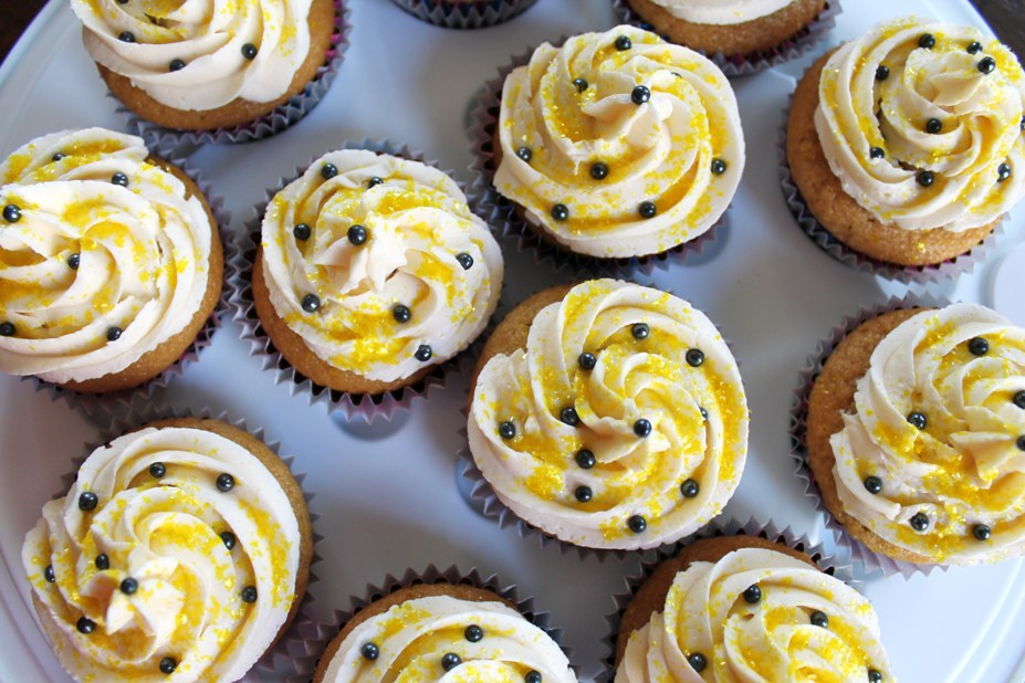 Overhead view of vegan vanilla cupakes with yellow sprinkles