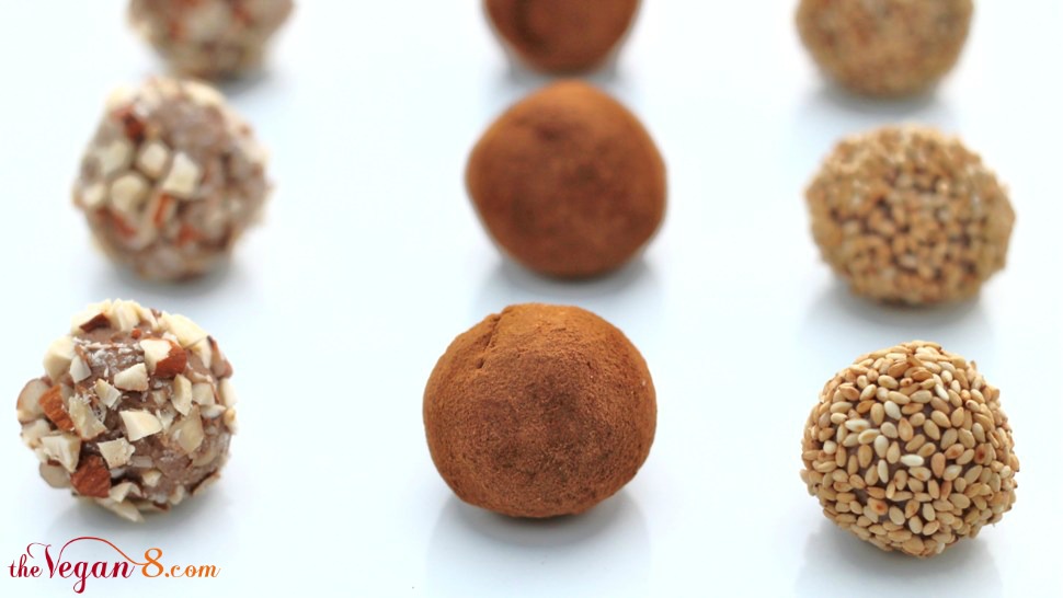 rows of truffles in coatings of cinnamon nuts and sesame seeds
