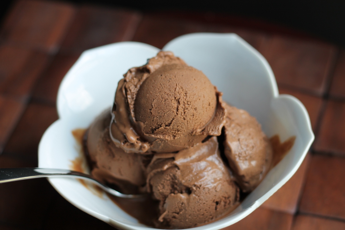 several scoops of vegan mocha chocolate ice cream in white bowl