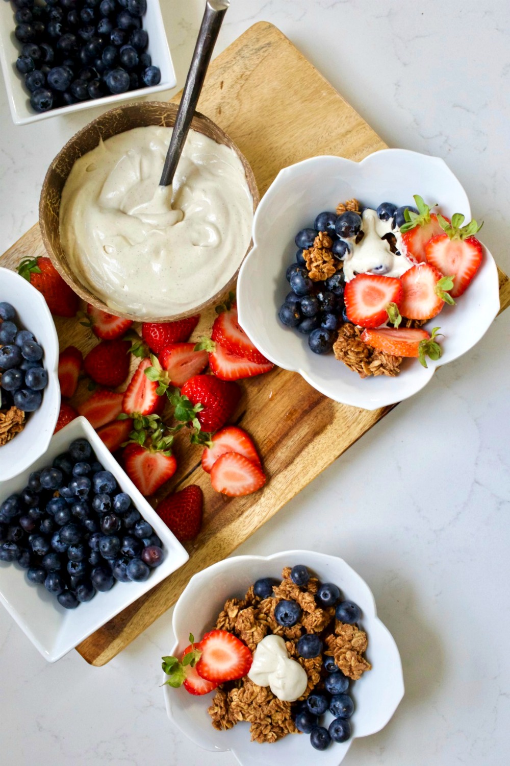 bowls of granola with fresh fruit and yogurt