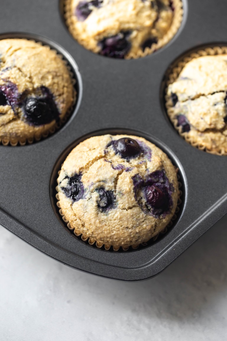 baked vegan blueberry muffins in muffin pan