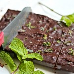 knife slicing through vegan mint chocolate fudge on parchment paper