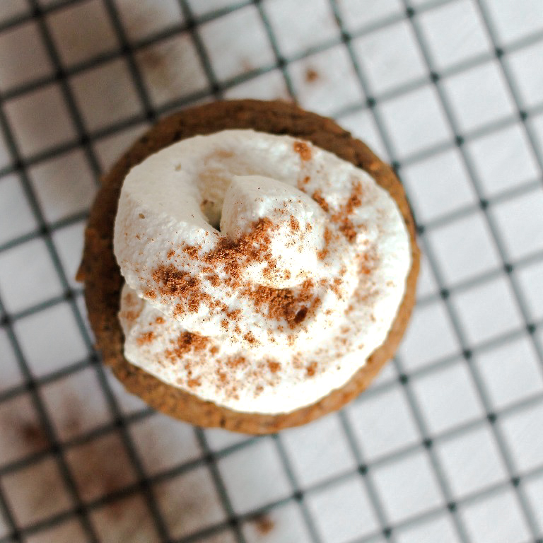 overhead closeup view of coconut whipped cream on muffin