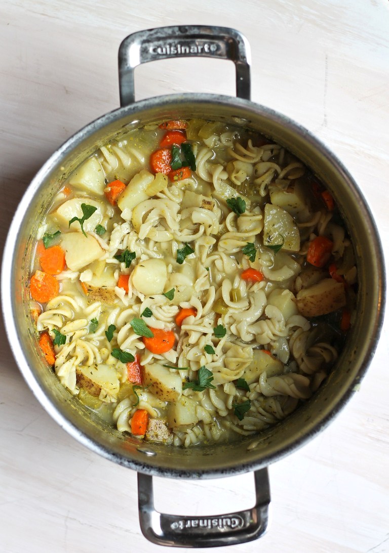 overhead shot of large pot of vegan chicken noodle soup