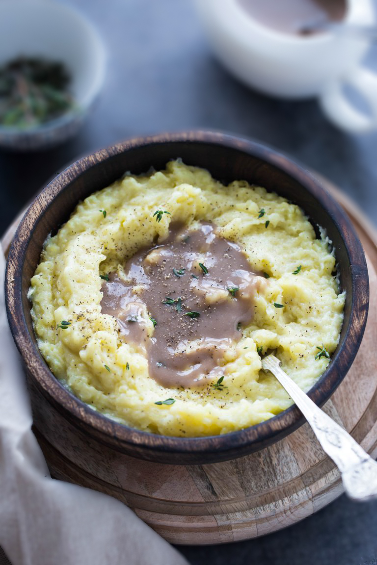 wooden bowl of vegan mashed potatoes with wine gravy