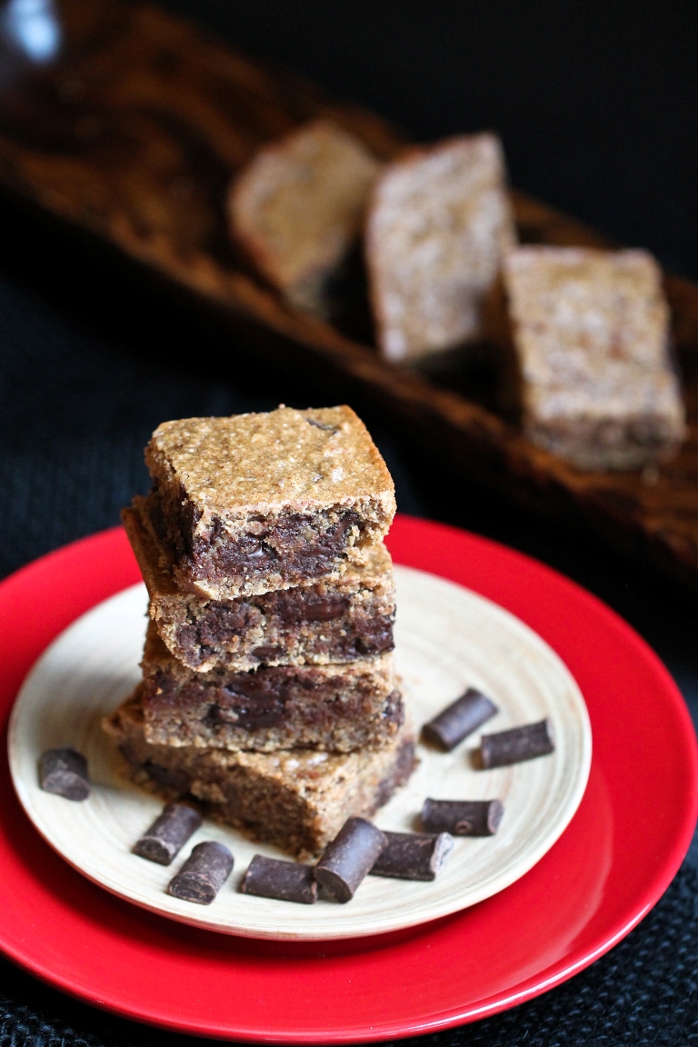 Stacked vegan almond butter blondies with chocolate chunks on plate