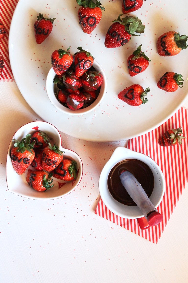Plate and bowl of healthy valentine's day strawberries candy