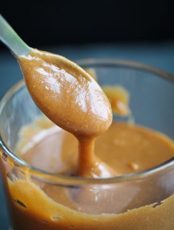 spoon drizzling peanut butter caramel