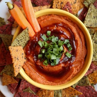 Yellow bowl of barbecue hummus and chips