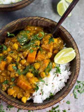 Vegan Sweet Potato Chickpea and Spinach Coconut Curry in wooden bowl