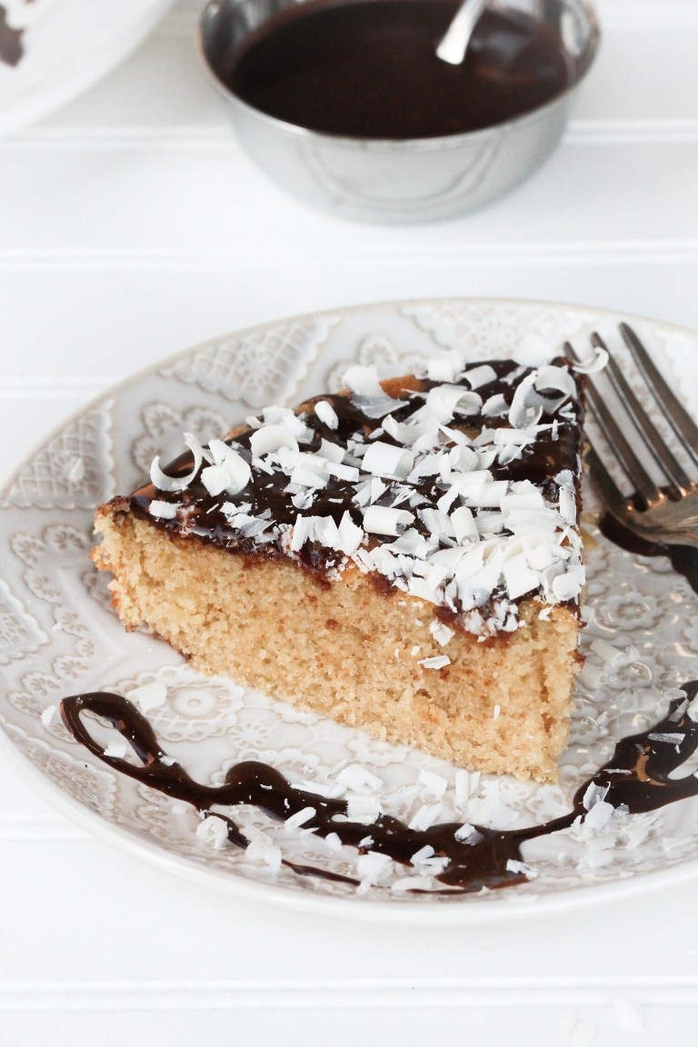 Slice of vegan vanilla cake with chocolate ganache