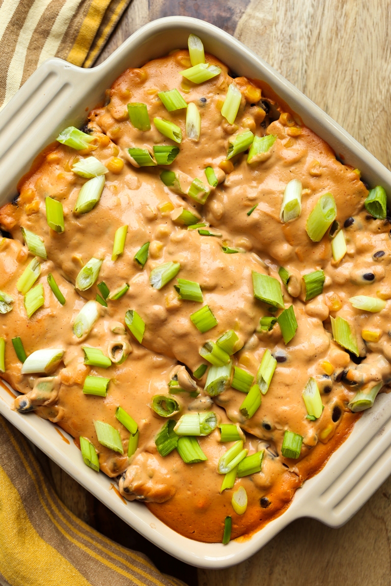 overhead view of Vegan Cheesy Mexican Tortilla Bake with green onions