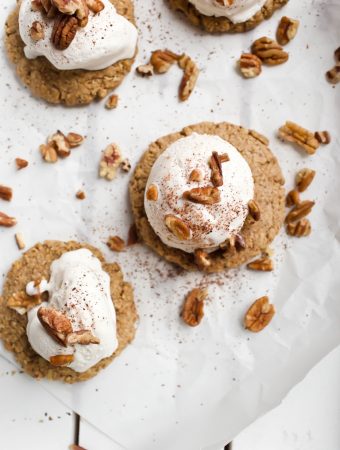 vegan pecan pie cookies with whipped cream on parchment paper