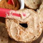 Spreading Vegan Apple Cinnamon Cream Cheese on bagel
