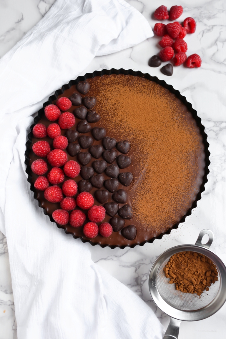 Vegan chocolate sweet potato tart with raspberries on top