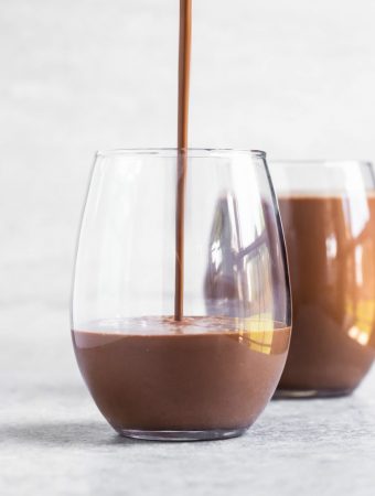 Pouring homemade vegan chocolate milk into glass