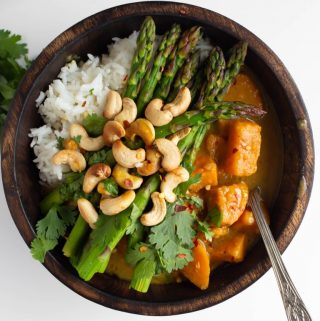 vegan Thai green curry sauce with sweet potatoes in wood bowl