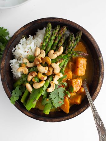 vegan Thai green curry sauce with sweet potatoes in wood bowl