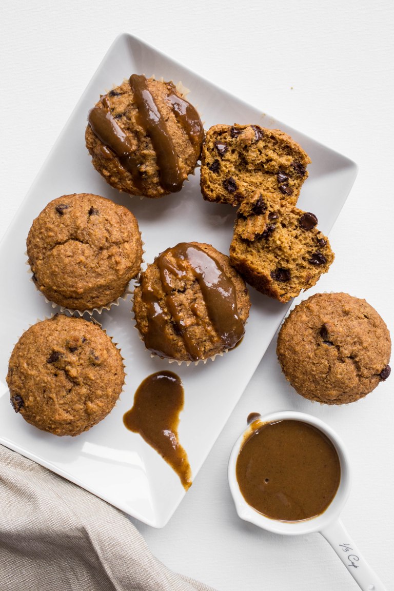 White platter with pumpkin chocolate chip muffins and caramel