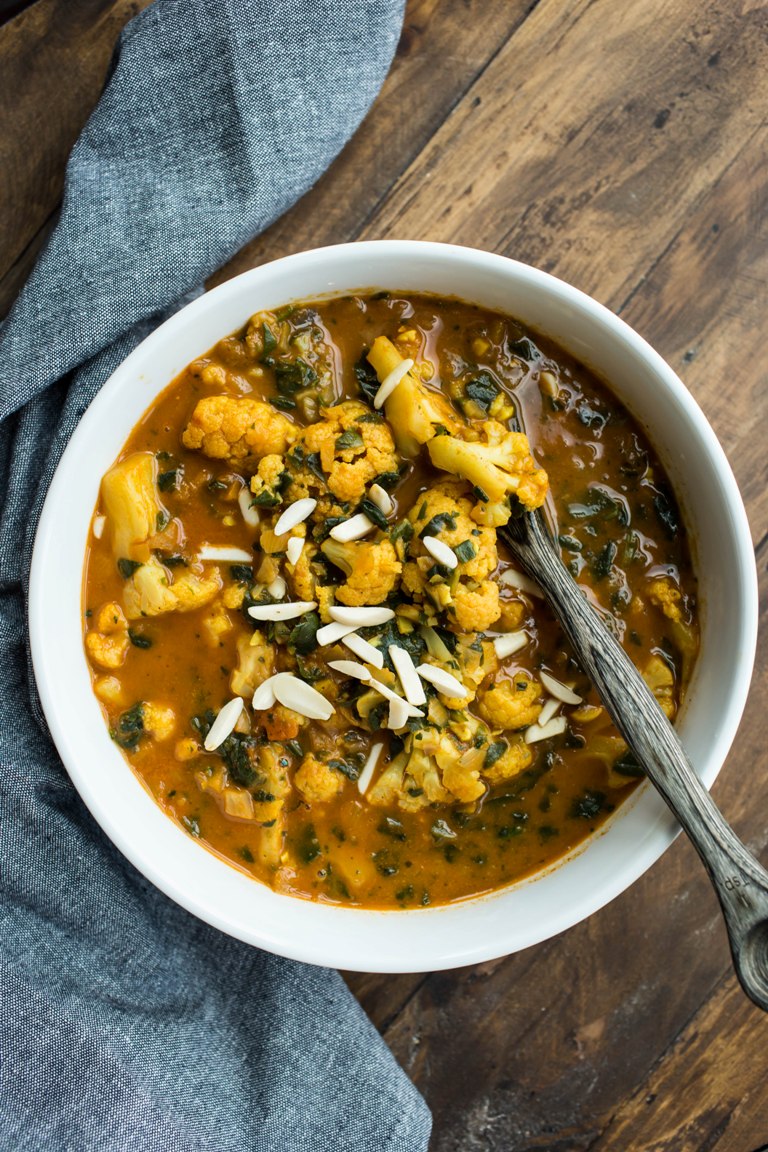 vegan cauliflower curry soup with spoon in bowl