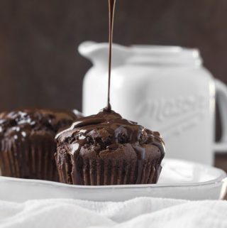 Vegan chocolate sauce drizzling above muffin