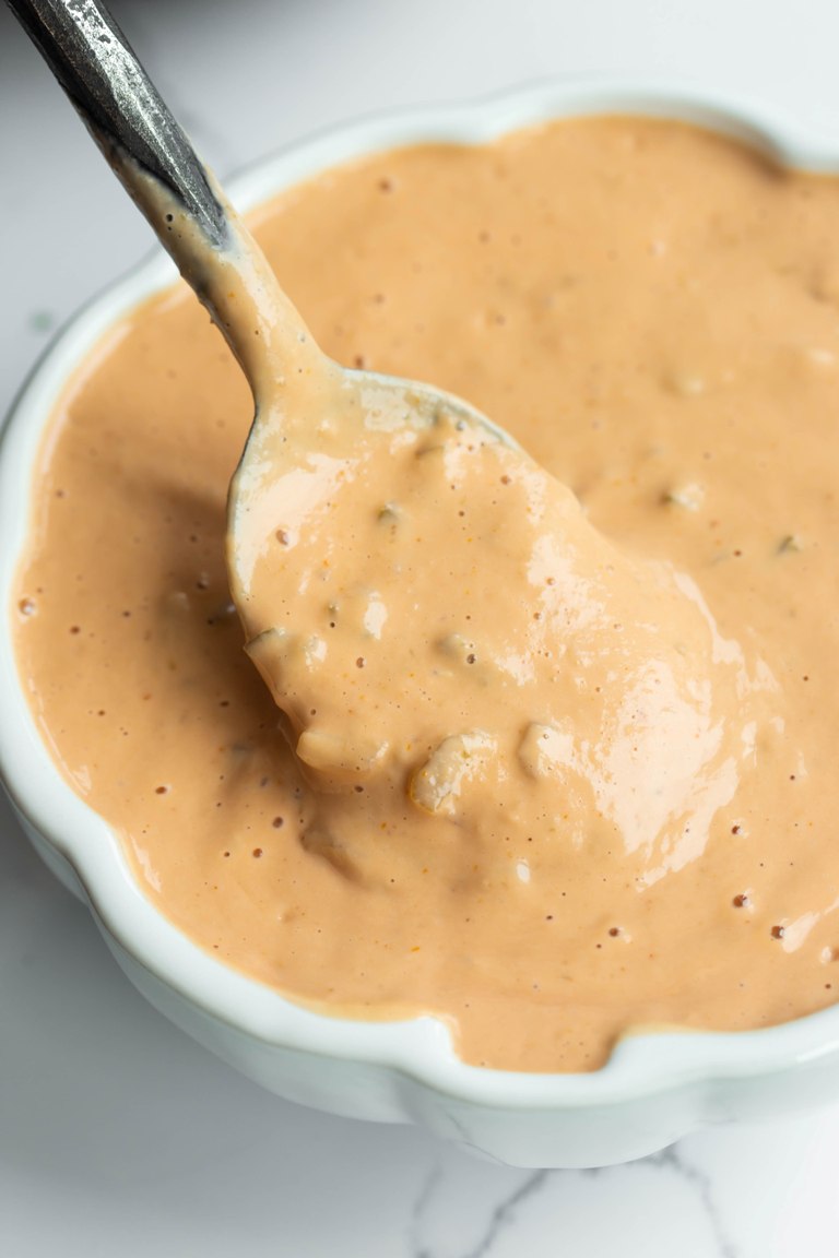 vegan thousand island dressing in white bowl with spoon