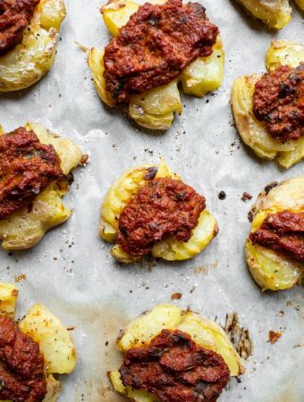 overhead view of smashed potatoes and sundried tomato pesto