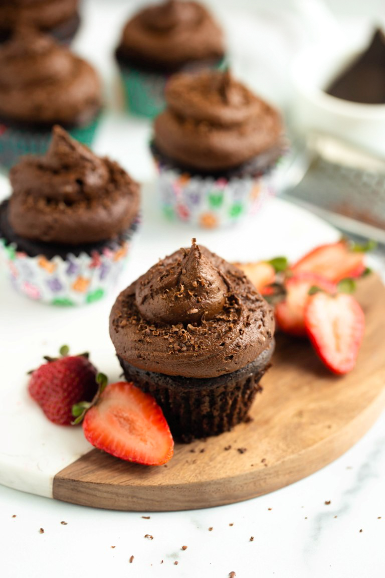 vegan chocolate cupcakes with strawberries on white board