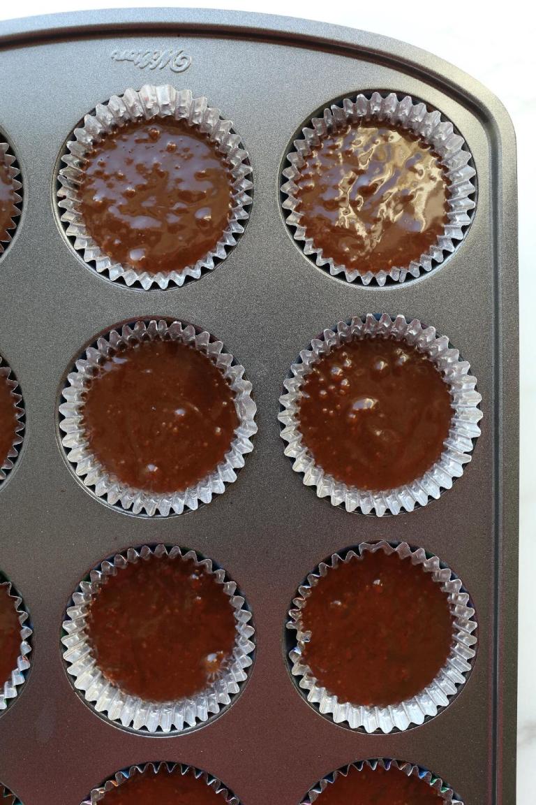 chocolate cupcake batter in muffin liners in pan