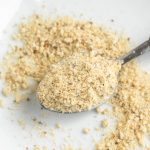 vegan lemon parmesan cheese sprinkled on plate with spoon