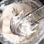 beaters inside bowl of frosting