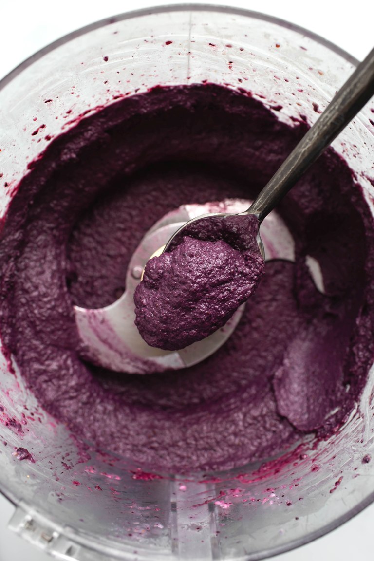 spoonful of blueberry cream cheese above food processor