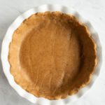pressed gluten-free dough in white pie dish