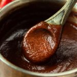 spoon of bbq sauce in pot