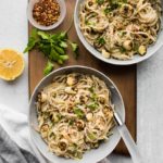 2 plates of vegan scampi on wooden board