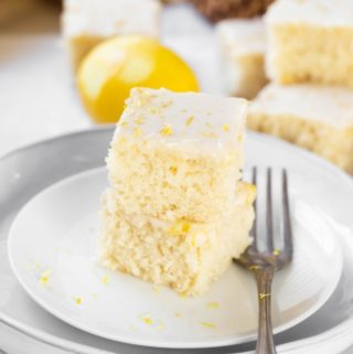 2 slices of lemon cake stacked on each other on white plate