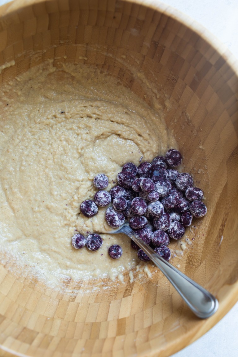 muffin batter in bowl with blueberries