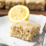 slice of lemon cake with fork on white plate