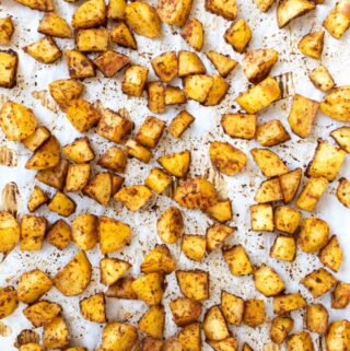 roasted potatoes on pan of parchment paper