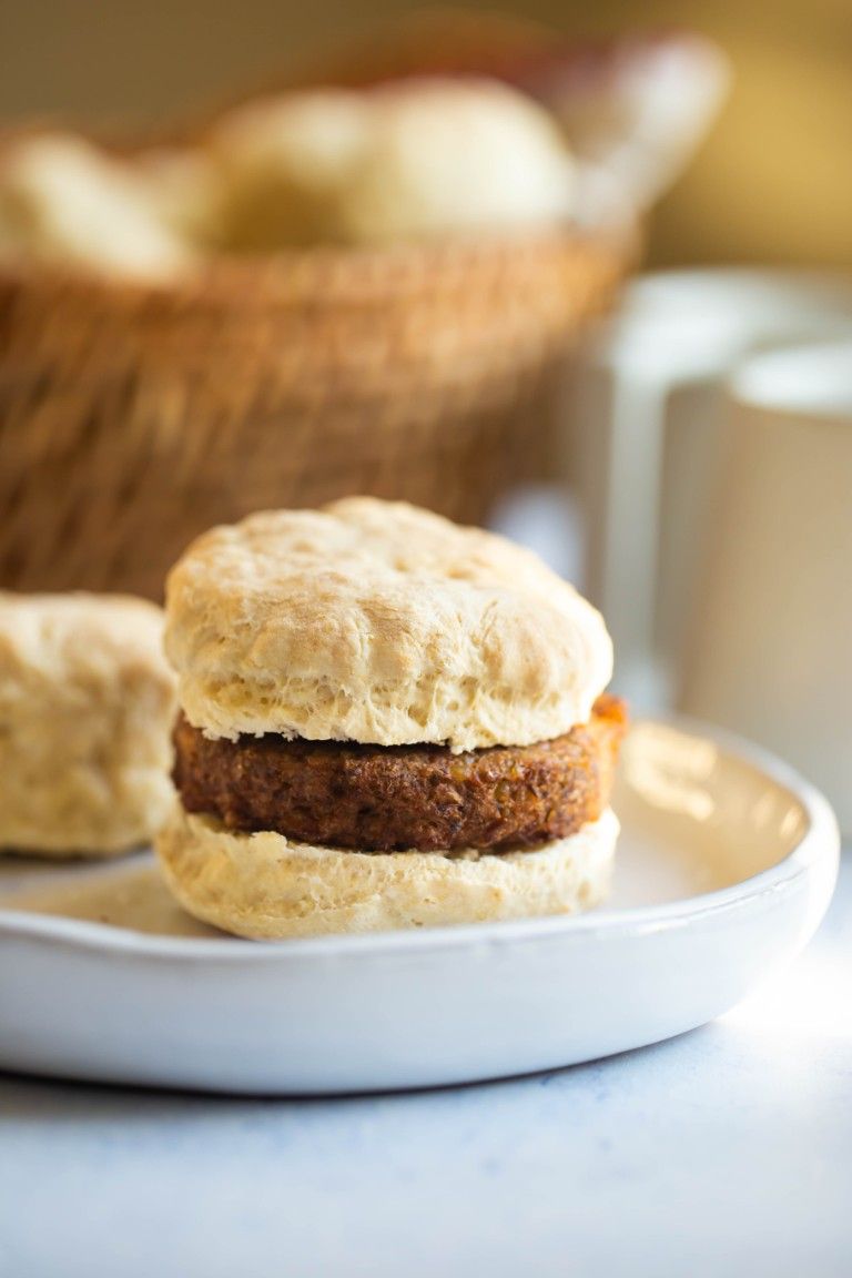 biscuit with vegan sausage inside on white plate