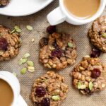 breakfast cookies with dried cherries on cookie sheet with coffee