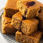 stack of beautiful golden vegan pumpkin cornbread on blue round plate
