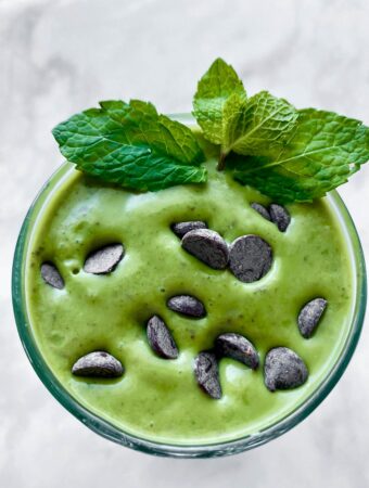 closeup overhead of mint chocolate smoothie with chocolate chips on top