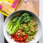 bowl of instant ramen on wood board with immi ramen packet