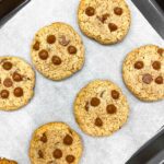 overhead shot of vegan macadamia nut chocolate chip cookies on tray