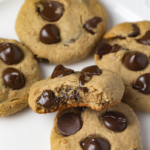 closeup of vegan protein cookies with chocolate chips on white plate