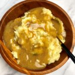 wooden bowl of vegan mashed potatoes and gravy