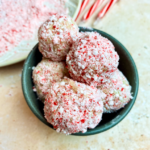 closeup of bowl of vegan white chocolate truffles with peppermints