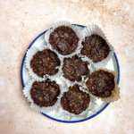 chocolate granola bites on white round plate